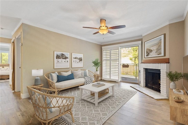 1710 S El Camino Real Unit E204, Encinitas, CA 92024 - living room with a ceiling fan, wood finished floors, a brick fireplace, and ornamental molding