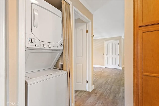 1710 S El Camino Real Unit E204, Encinitas, CA 92024 - washroom with estacked washer and dryer and light wood-style flooring