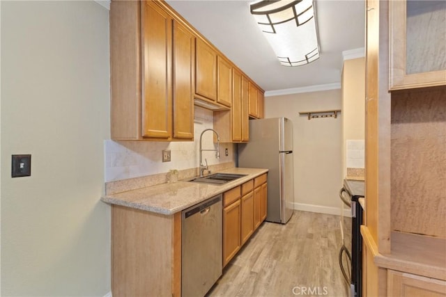 1710 S El Camino Real Unit E204, Encinitas, CA 92024 - kitchen featuring appliances with stainless steel finishes, ornamental molding, light wood finished floors, backsplash, and light stone counters