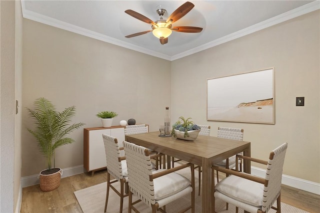 1710 S El Camino Real Unit E204, Encinitas, CA 92024 - dining space featuring wood finished floors, a ceiling fan, and crown molding