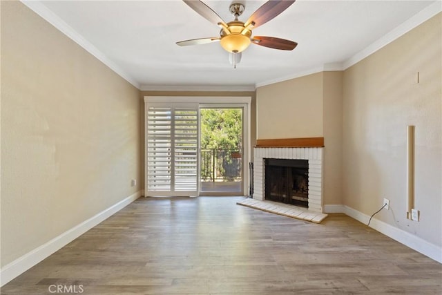 1710 S El Camino Real Unit E204, Encinitas, CA 92024 - unfurnished living room featuring a brick fireplace, wood finished floors, crown molding, and a ceiling fan