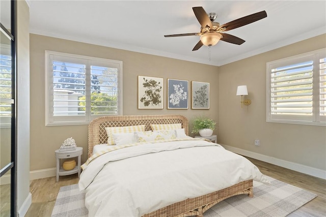 1710 S El Camino Real Unit E204, Encinitas, CA 92024 - bedroom with multiple windows, wood finished floors, ornamental molding, and a ceiling fan