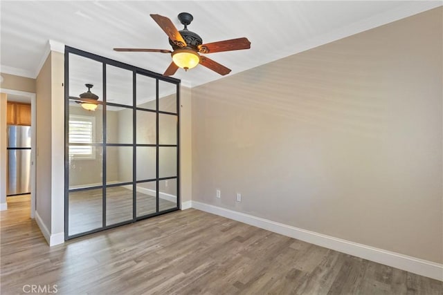 1710 S El Camino Real Unit E204, Encinitas, CA 92024 - empty room with a ceiling fan, ornamental molding, and wood finished floors