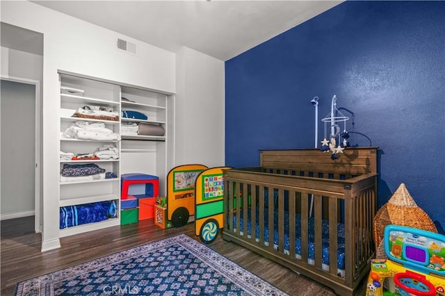 5722 E Stillwater Ave Unit 104, Orange, CA 92869 - bedroom with wood finished floors and a nursery area