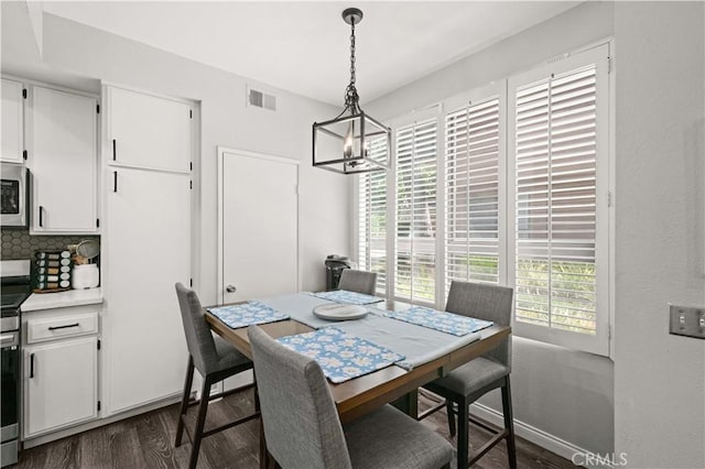 5722 E Stillwater Ave Unit 104, Orange, CA 92869 - dining area with a chandelier and dark wood-style floors