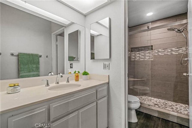 5722 E Stillwater Ave Unit 104, Orange, CA 92869 - full bath with vanity, a shower stall, wood finished floors, and recessed lighting