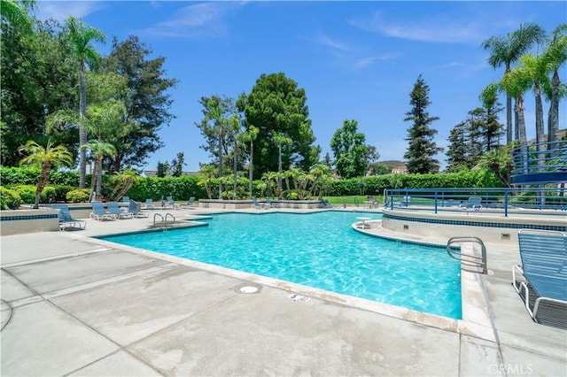 5722 E Stillwater Ave Unit 104, Orange, CA 92869 - community pool with a patio area and view of scattered trees