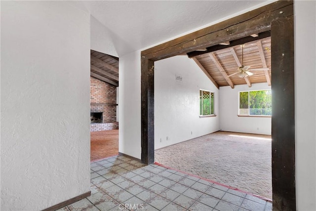 19215 Hupa Rd, Apple Valley, CA 92307 - carpeted empty room with wood ceiling, a ceiling fan, a brick fireplace, tile patterned floors, and a textured wall