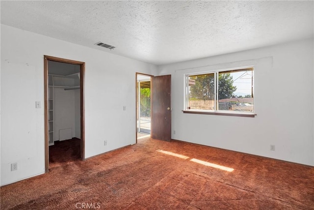19215 Hupa Rd, Apple Valley, CA 92307 - unfurnished bedroom featuring carpet, a textured ceiling, and a spacious closet