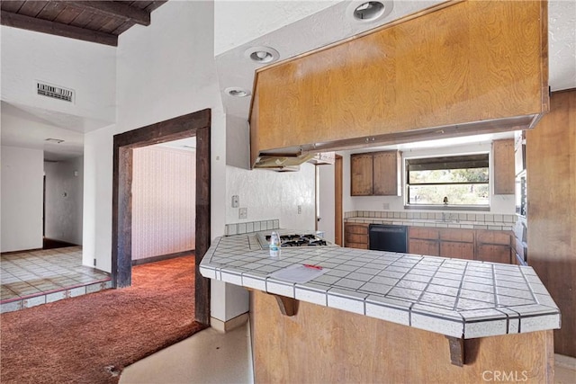 19215 Hupa Rd, Apple Valley, CA 92307 - kitchen featuring tile countertops, black dishwasher, stainless steel gas cooktop, a wood ceiling with exposed beams, and a peninsula