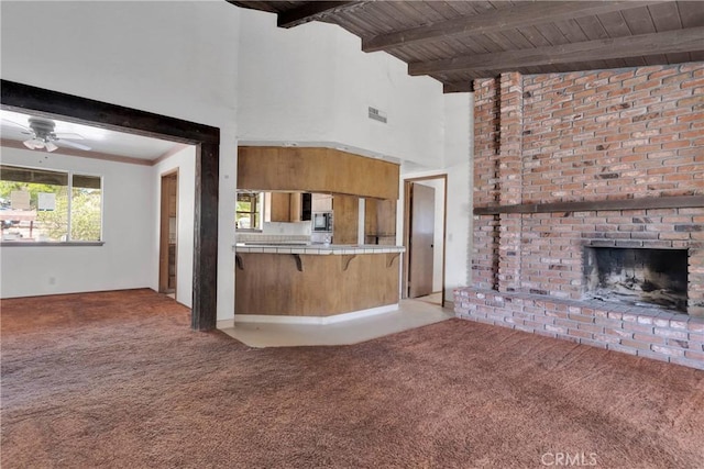 19215 Hupa Rd, Apple Valley, CA 92307 - kitchen featuring tile counters, carpet flooring, a high ceiling, a fireplace, and ceiling fan