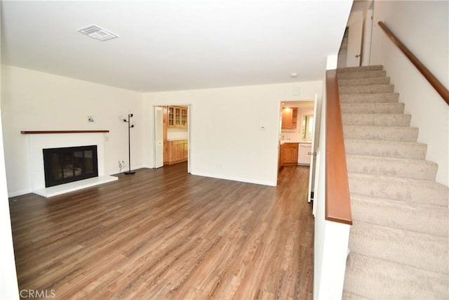 23814 Walnut St, Torrance, CA 90501 - unfurnished living room featuring wood finished floors, stairs, and a glass covered fireplace