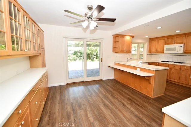 23814 Walnut St, Torrance, CA 90501 - kitchen with white microwave, stovetop, backsplash, dark wood-style floors, and recessed lighting