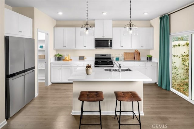 25165 Hunter Ave, Moreno Valley, CA 92551 - kitchen with stainless steel appliances, light wood-style floors, light countertops, white cabinets, and recessed lighting