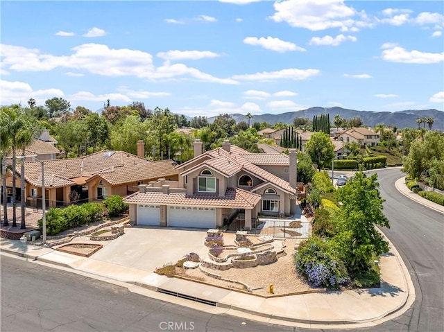 29813 Via Sevilla, Temecula, CA 92591 - mediterranean / spanish house featuring stucco siding, a tiled roof, driveway, a chimney, and a mountain view