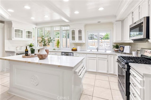29813 Via Sevilla, Temecula, CA 92591 - kitchen with appliances with stainless steel finishes, ornamental molding, white cabinets, light tile patterned floors, and glass insert cabinets