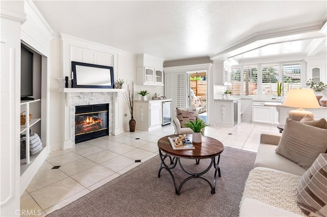 29813 Via Sevilla, Temecula, CA 92591 - living area with light tile patterned flooring, a glass covered fireplace, healthy amount of natural light, crown molding, and beverage cooler