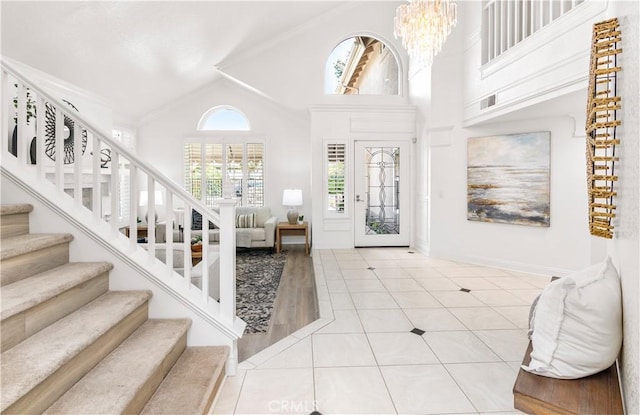 29813 Via Sevilla, Temecula, CA 92591 - tiled entryway with high vaulted ceiling, a chandelier, crown molding, and stairway