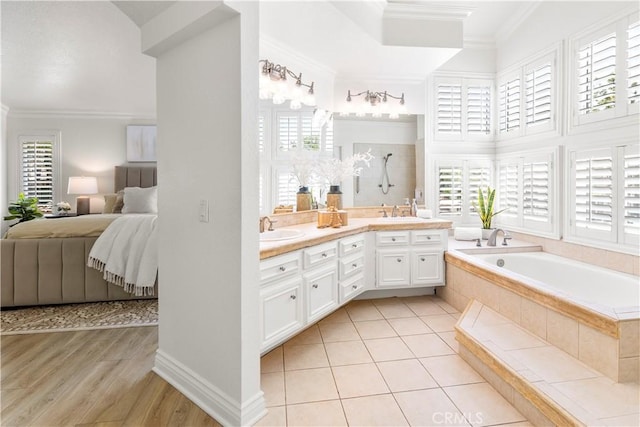 29813 Via Sevilla, Temecula, CA 92591 - ensuite bathroom featuring healthy amount of natural light, a garden tub, ornamental molding, double vanity, and wood finished floors