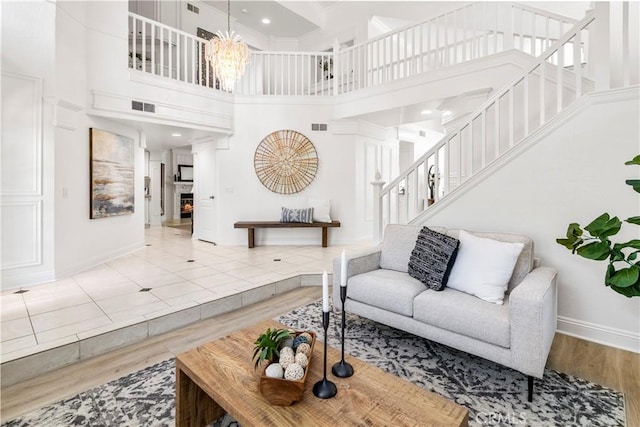 29813 Via Sevilla, Temecula, CA 92591 - living room with a high ceiling, stairway, wood finished floors, and a chandelier