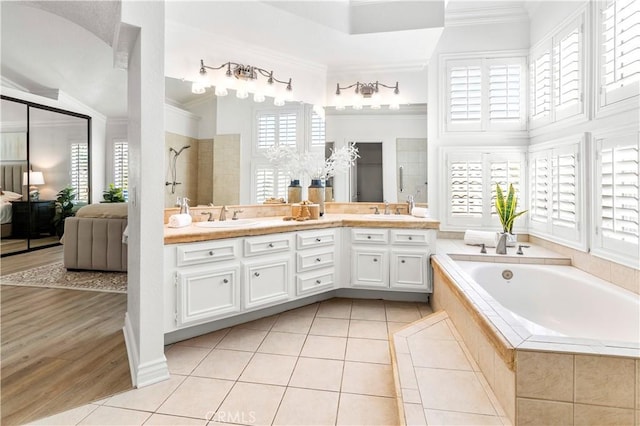29813 Via Sevilla, Temecula, CA 92591 - bathroom featuring crown molding, double vanity, a garden tub, tile patterned floors, and tiled shower