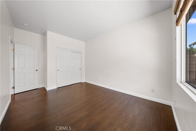 28677 Sunridge Ct, Menifee, CA 92584 - unfurnished bedroom with dark wood-style floors and a closet