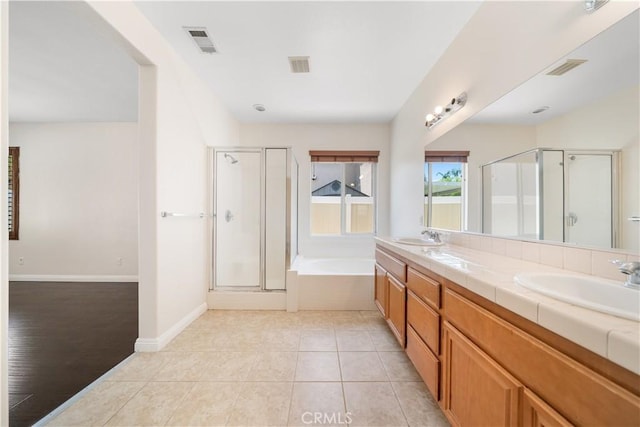 28677 Sunridge Ct, Menifee, CA 92584 - bathroom with a shower stall, a garden tub, double vanity, and tile patterned flooring