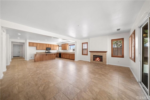 28677 Sunridge Ct, Menifee, CA 92584 - unfurnished living room with a lit fireplace and recessed lighting