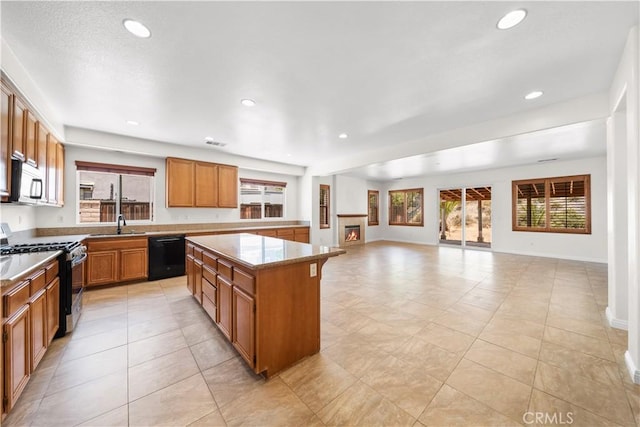 28677 Sunridge Ct, Menifee, CA 92584 - kitchen featuring range with gas cooktop, black dishwasher, a center island, healthy amount of natural light, and recessed lighting