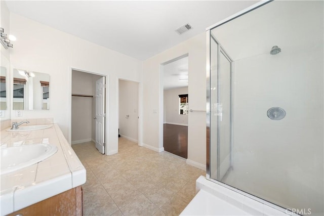 28677 Sunridge Ct, Menifee, CA 92584 - bathroom featuring a shower stall, double vanity, and tile patterned floors