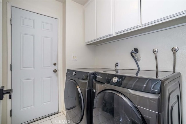 23235 Redbud Ridge Cir, Valencia, CA 91354 - laundry area featuring washer and clothes dryer, cabinet space, and light tile patterned floors