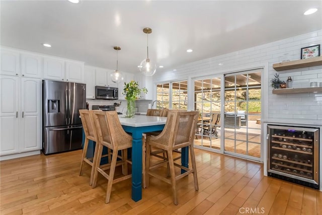 23235 Redbud Ridge Cir, Valencia, CA 91354 - dining room featuring wine cooler, light wood-style floors, plenty of natural light, and recessed lighting