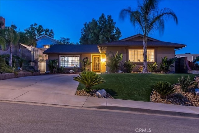 23235 Redbud Ridge Cir, Valencia, CA 91354 - ranch-style home with a front yard, stucco siding, and concrete driveway