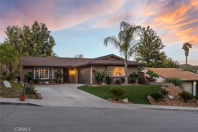 23235 Redbud Ridge Cir, Valencia, CA 91354 - ranch-style house with a garage, stucco siding, concrete driveway, and a front lawn