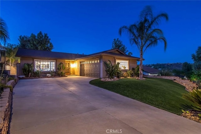 23235 Redbud Ridge Cir, Valencia, CA 91354 - ranch-style house with stucco siding, an attached garage, a yard, and concrete driveway