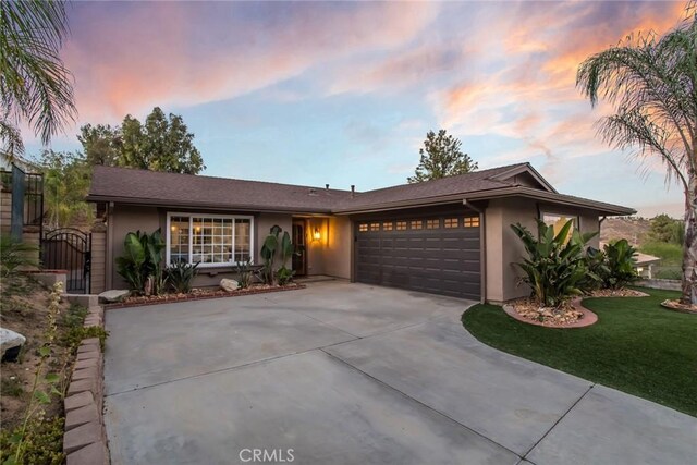23235 Redbud Ridge Cir, Valencia, CA 91354 - single story home with stucco siding, a garage, driveway, a front yard, and a gate