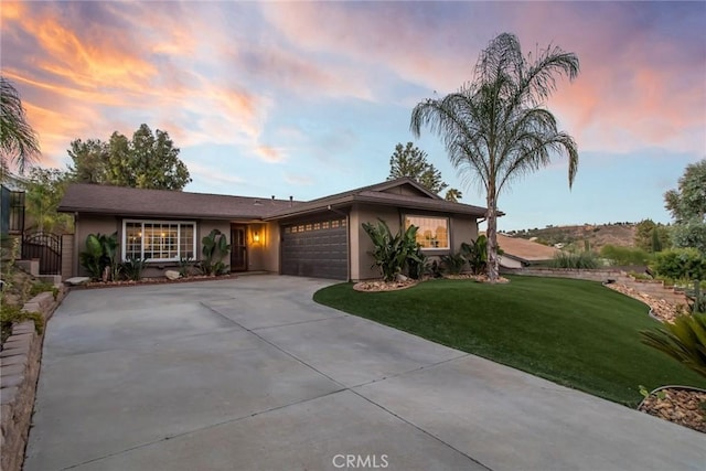 23235 Redbud Ridge Cir, Valencia, CA 91354 - ranch-style house featuring an attached garage, a front yard, driveway, and stucco siding