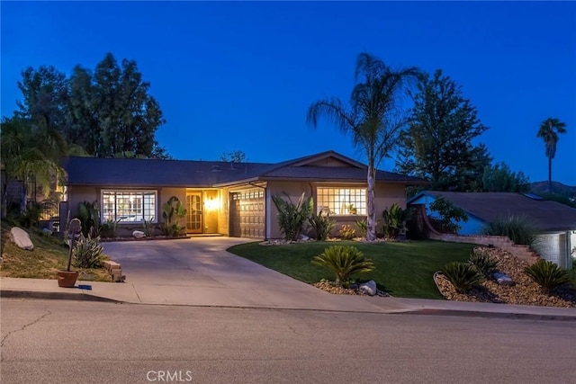23235 Redbud Ridge Cir, Valencia, CA 91354 - single story home featuring concrete driveway, stucco siding, a yard, and a garage