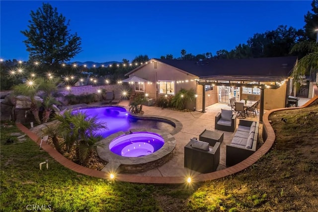 23235 Redbud Ridge Cir, Valencia, CA 91354 - pool at night with an in-ground hot tub and a patio area
