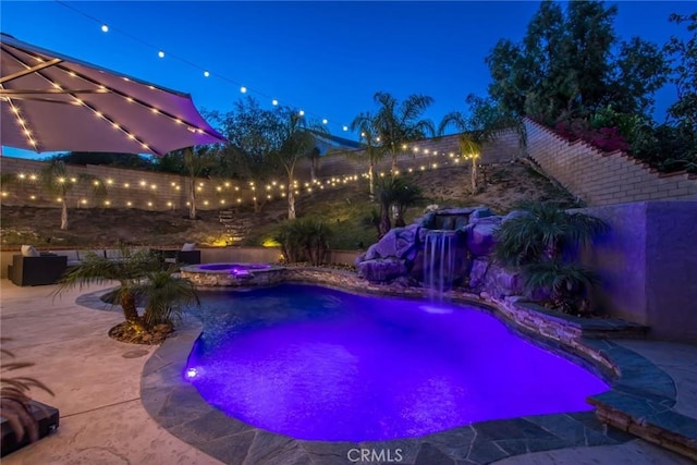 23235 Redbud Ridge Cir, Valencia, CA 91354 - pool at night with a patio area, a fenced backyard, and a pool with connected hot tub