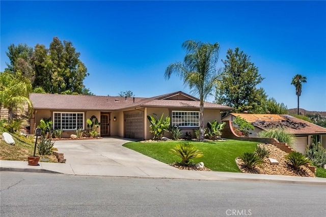 23235 Redbud Ridge Cir, Valencia, CA 91354 - single story home with an attached garage, concrete driveway, a front yard, and stucco siding