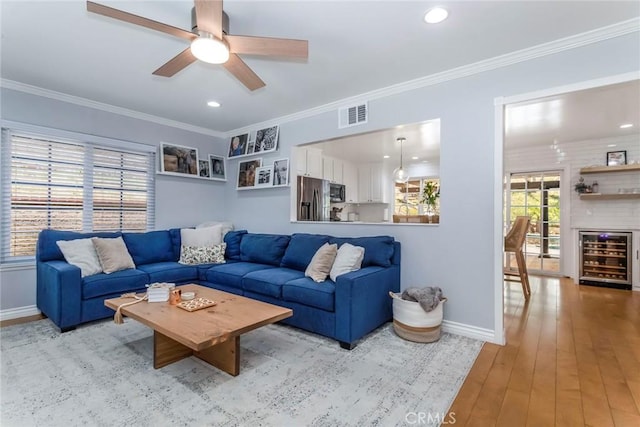 23235 Redbud Ridge Cir, Valencia, CA 91354 - living area featuring beverage cooler, ceiling fan, ornamental molding, light wood finished floors, and recessed lighting