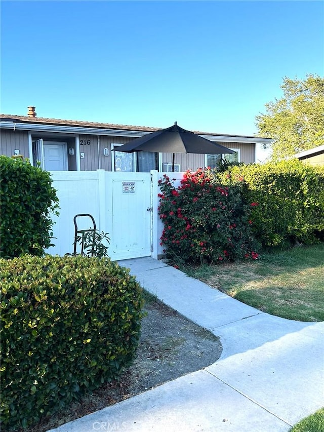 25821 Via Lomas Unit 216, Laguna Hills, CA 92653 - view of home's exterior featuring a gate