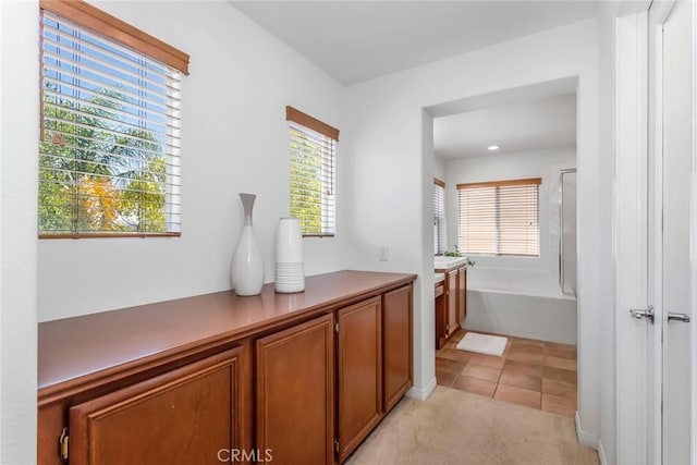 27960 Agapanthus Ln, Valencia, CA 91354 - hallway with light carpet and light tile patterned floors