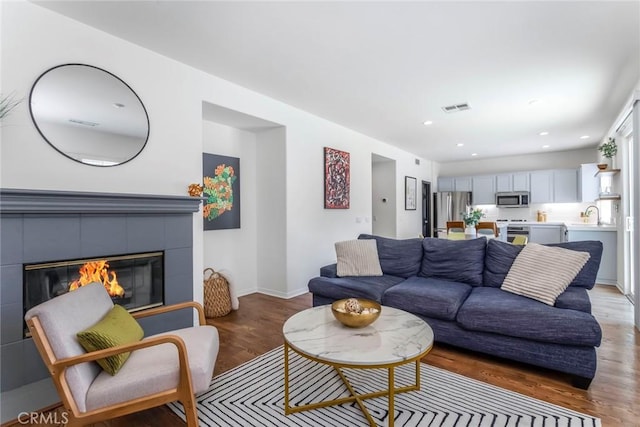27960 Agapanthus Ln, Valencia, CA 91354 - living area with light wood-type flooring, a fireplace, and recessed lighting
