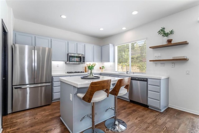 27960 Agapanthus Ln, Valencia, CA 91354 - kitchen featuring stainless steel appliances, a kitchen island, dark wood finished floors, a breakfast bar, and recessed lighting