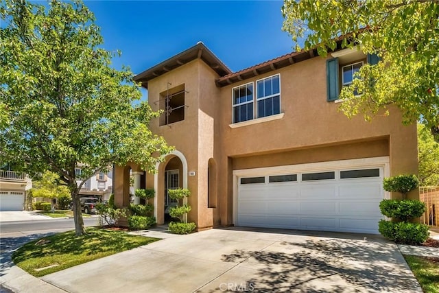 27960 Agapanthus Ln, Valencia, CA 91354 - view of front of property with stucco siding, driveway, and a garage