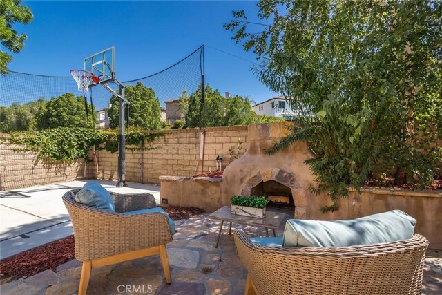 27960 Agapanthus Ln, Valencia, CA 91354 - view of patio / terrace featuring an outdoor stone fireplace