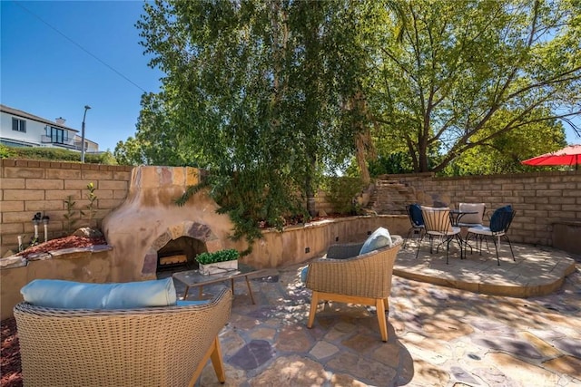 27960 Agapanthus Ln, Valencia, CA 91354 - view of patio with an outdoor stone fireplace