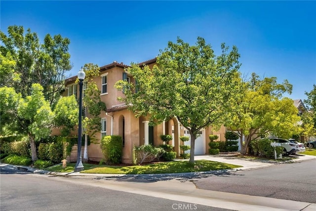 27960 Agapanthus Ln, Valencia, CA 91354 - view of front of home with a garage, driveway, and stucco siding